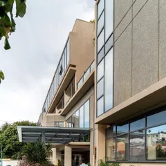 The entrance to the Koramangala Club Annexe. The design uses a simple and modern material palette to create a building that is contemporary yet respectful of the existing club structures on the campus.