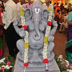 Every event begins with a prayer. A beautiful Ganesha idol adorned with garlands at the entrance of a marriage ceremony, seeking blessings for the event.