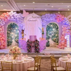 For a touch of magic, I design enchanting worlds like this "Fairyland" theme. The setup includes custom-built sparkling arches, whimsical fairy cutouts, and coordinated table settings to bring the entire fairytale to life.