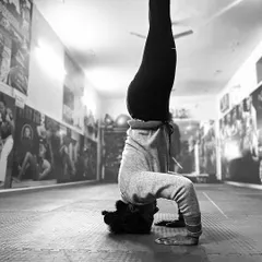 A moment of pure balance and strength. This student executes a flawless headstand in our academy, demonstrating the control and focus that is central to my gymnastics training philosophy.