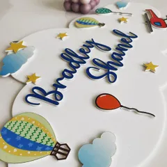 This cloud-shaped name board is all about sweet dreams and sky-high adventures. I designed it with hot air balloons, fluffy clouds, and bright stars to create a whimsical scene that can be personalized with one or two names.