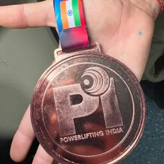 A close up of the bronze medal won by my student Sonia Dhaka in her very first Junior National Powerlifting Championship, lifting a total of 432.5 kg.