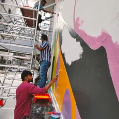 A work-in-progress shot of a huge mural for a sports arena in a Hyderabad tech office. It takes a team of dedicated artists on scaffolding to tackle a wall this big.