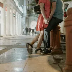 An intimate kiss on a bollard in Connaught Place. This shot captures a private moment amidst the public setting of Delhi's city center.