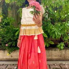 Here is the Nila set, beautifully captured. The peplum top with a traditional Kasavu border and the peach cotton skirt with delicate motifs create an elegant look that's still incredibly comfortable for all-day wear.