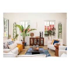 In this tropical villa, the living room is filled with light and greenery. We selected furniture and decor that are relaxed and inviting, with plenty of comfortable seating and natural elements to blur the line between the indoors and the lush Goan landscape outside.
