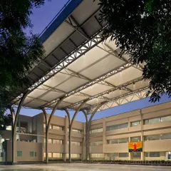 This 12,000 sq ft tensile canopy at SMR Jaipuria School provides an all-weather, climate-responsive solution for outdoor activities. The structure's elegant arches and integrated lighting create a functional and visually striking assembly area, usable day and night, rain or shine.