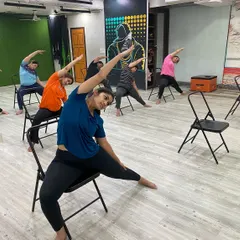 Our members using chairs to support a side-body stretch, which helps improve flexibility in the spine and waist.