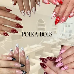 A playful and timeless choice, polka dot nail art can be customized in any color combination. This collage shows various styles, from classic red and white to modern black-tipped French manicures with dots.