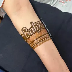 A close up of the "Baby" armband. This is a fun and trendy way to announce your joy. I can customize the font and surrounding patterns to match your style.