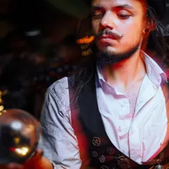 The artist gazes into the crystal ball, creating a moment of quiet magic. This act is perfect for walk-around entertainment or as a calming interlude in a larger show.