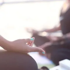 A close-up of a student in meditation during our yacht yoga session. The sunlight and open sea create a perfect backdrop for finding inner peace.