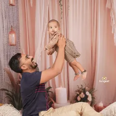 Pure joy and laughter between a father and his child. Playful, interactive moments like this create the most natural and heartwarming family photographs.