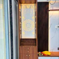 A beautiful wooden mandir unit with a backlit acrylic panel featuring sacred symbols. This unit is designed to stand next to the TV console, integrating seamlessly into the living room.