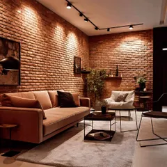 In this project, I used exposed brick on multiple walls to create a cohesive, warm, and industrial-inspired living room, enhanced by modern track lighting.