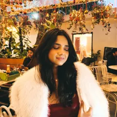A candid moment during our Christmas outing. The white fur jacket adds a touch of glamour and warmth to the simple red velvet dress.