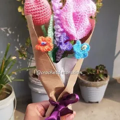This custom bouquet features a mix of a pink tulip, a large pink flower, and smaller complementary flowers in orange, purple, and blue. It showcases our ability to combine different flower types and colors to match your vision.
