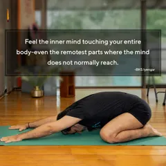 A student practices Balasana (Child's Pose), feeling the inner mind touch every part of the body, as B.K.S. Iyengar taught. This is a pose of surrender and deep introspection.