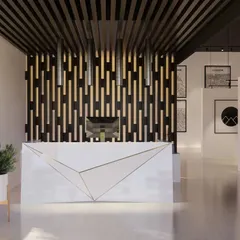 The reception for this conceptual marketing office features an asymmetrical desk and a dramatic backlit background. The design breaks away from typical office entries, creating an interesting and artistic atmosphere that gives visitors a sneak peek of the gallery-like space within.