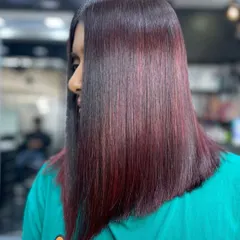A sleek and modern lob (long bob) with a rich, reddish-purple color. This straight, polished style is sophisticated and makes a bold statement.