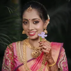 A classic bridal portrait. The bride holds a single flower, her expression a perfect blend of elegance and happiness.