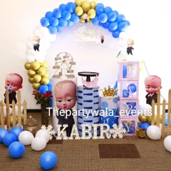 Another look at the Boss Baby first birthday party. The setup includes a mini Ferris wheel prop and a cute picket fence for a charming touch.