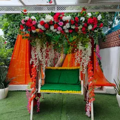 A beautifully decorated swing or 'jhoola' is a popular addition to any Mehndi or Haldi function. I adorned this one with a mix of red, pink, and white flowers and hanging floral strings.