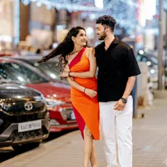 A couple walks down a brightly lit Bangalore street at night, their laughter captured in a candid moment. This photo demonstrates my ability to create vibrant, modern portraits in an urban setting.