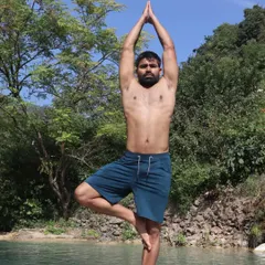 Practicing Vrikshasana, or Tree Pose, by the water. This pose is excellent for improving balance, strengthening the legs and core, and cultivating a sense of groundedness and stability.