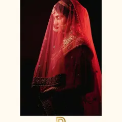 I love creating dramatic bridal portraits that feel timeless and artistic. Using shadow and a single source of light, we captured the bride's serene beauty under her red veil.