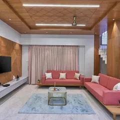 A closer look at the living area, showing the textured wood paneling on the TV wall and the patterned ceiling detail. These elements add layers of visual interest and a sense of bespoke craftsmanship.