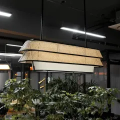 Our modern two-tiered rattan chandelier combines traditional weaving with a sleek, contemporary design. The black metal frame contrasts beautifully with the natural cane webbing, making it a sophisticated statement piece for offices, dining rooms, or hotel lobbies.