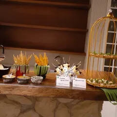 A stationary appetizer bar featuring cheese and olive skewers, bruschetta, and various crisps with dips. This provides a self-service option for guests to graze at their leisure.
