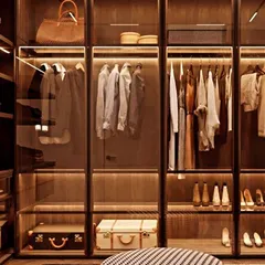 This is what a dream walk-in closet looks like. We used profile glass shutters to create a boutique-like display, while warm interior lighting highlights the collection and makes finding the perfect outfit effortless.