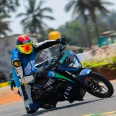 We're also pushing the boundaries of electric motorsports. Here I am coaching on the track, demonstrating how to get the most out of these silent but incredibly powerful EV race bikes.