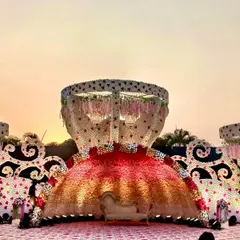 This reception stage was a true showstopper, designed to look like a magnificent floral sculpture. The unique, multi-layered structure adorned with thousands of flowers created an unforgettable backdrop for the couple's celebration.