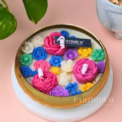 Another view of my technicolor floral Urli candle, showing the mix of pink, blue, and yellow flowers. Each one is uniquely arranged, so no two candles are exactly alike.