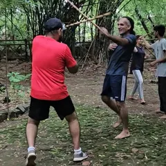 Training isn't confined to four walls. Here in the forest, we practice stick fighting drills, learning to use our environment and stay aware. This is what I mean by being ready for anything, anywhere.