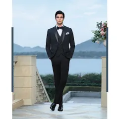 A three-piece patterned suit styled for a Louis Philippe campaign at Raffles Udaipur. The full-length shot showcases the sharp tailoring and fit, set against the serene backdrop of the lake to create a look of relaxed luxury.