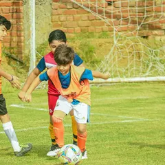 Our players battling for possession during a U8 Pride Cup match. We teach them to be strong and confident on the ball.