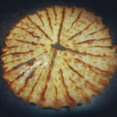 This is Khoba Roti, a traditional Rajasthani bread known for its distinctive pinched design. It's cooked over an open fire to get that authentic, smoky flavour and rustic texture.