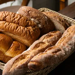 A basket filled with an assortment of my freshly baked breads. From crusty baguettes to soft loaves, each one is made with care and serves as the foundation for my sandwiches and toasts.