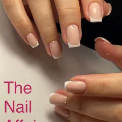 A soft and classic French manicure on short, square nails, with a tiny rhinestone accent at the cuticle for a subtle touch of sparkle.