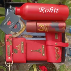 For the one who loves red, this vibrant gift hamper is a perfect choice. It features a full set of personalized red accessories including a wallet, passport holder, eyewear case, keychain, pen, and a matching temperature bottle.