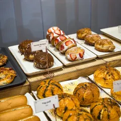 A look at our dessert counter, featuring rows of Nutella and Strawberry Berliners alongside our savory Veg Puffs and Korean Buns.