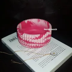 A different angle of the pink marbled ribbed jar. The unique patterns created during the pouring process mean that no two pieces are ever exactly alike.