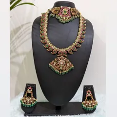 A versatile Jadau haara that can be styled in multiple ways. This set, with its matching choker and earrings, is perfect for a muhurtham look and can be mixed and matched for other events.