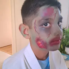 An example of costume prosthetic makeup. For this zombie look, I used special effects techniques to create the illusion of bruised, decaying skin and bloody wounds, perfect for film or a Halloween costume.