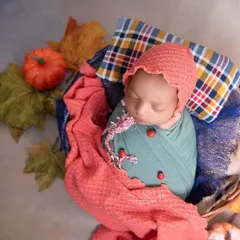 A little gentleman with his lucky ladybugs, ready for autumn. The mix of plaid, warm colors, and a tiny pumpkin creates a cozy and festive fall portrait.