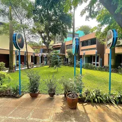 A wider view of the revamped Rosary Garden at the Portuguese Church. The open lawn is framed by carefully selected trees and shrubs, creating a serene and peaceful atmosphere in the heart of the city.